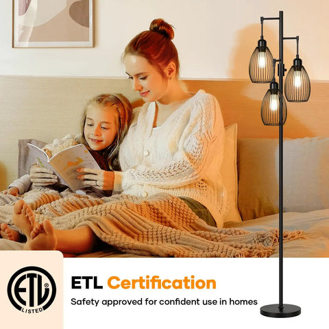 Dimmable Farmhouse Industrial Floor Lamp With Teardrop Cage Includes 3 X 800LM LED Edison Bulbs That Builds Cozy Vibe Tall Tree Style Standing Lamp For Living Room Bedroom Office Or Dining Room Black shown in cozy living room setting with family reading.