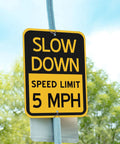 6 Pack Bright Yellow Slow Down 5 MPH Speed Limit Signs Durable Reflective Aluminum Street Safety Boards No Sweat Setup For Driveways Parking Lots And Rental Properties, close-up of reflective sign