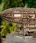 Close-up of Luminous Zeppelin LED 3D Wooden Puzzle Kit for Adults with intricate laser-cut details, displayed outdoors.