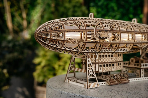 Close-up of Luminous Zeppelin LED 3D Wooden Puzzle Kit for Adults with intricate laser-cut details, displayed outdoors.