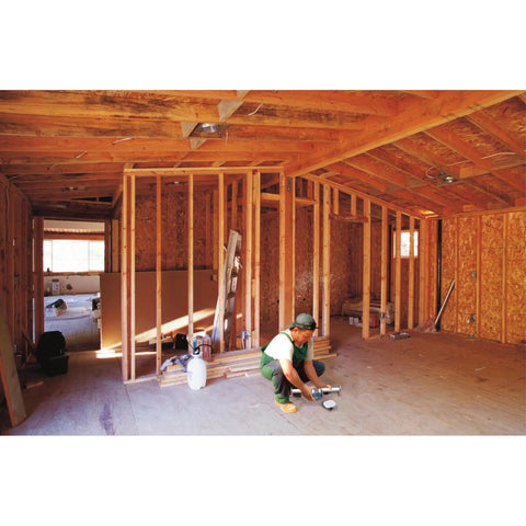 Person installing Saf-T-Bar Ceiling Fan Mount Kit for safe DIY install in new construction with exposed wooden framing.