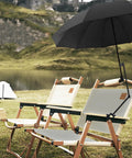 Portable UPF 50 Plus Beach Umbrella With Adjustable Universal Clamp attached to chair by lake