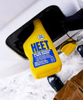Water Removal and Gas Line Antifreeze for Winter Starts Keeps Your Fuel System Free of Water Prevents Gas Line Freezing and Rust Protection Plus Easy Starts in Cold Weather 12 Fl Oz bottle inserted in a car's fuel cap opening in a snowy setting