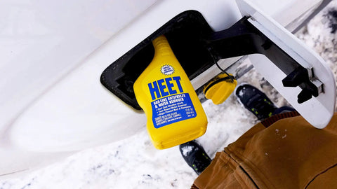 Water Removal and Gas Line Antifreeze for Winter Starts Keeps Your Fuel System Free of Water Prevents Gas Line Freezing and Rust Protection Plus Easy Starts in Cold Weather 12 Fl Oz bottle inserted in a car's fuel cap opening in a snowy setting