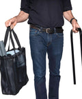 Man holding a black bag with cleaning tools and a metal handle, featuring Heavy Duty Commercial Steam Cleaner Kickin Out Stubborn Grime With Chemical Free Power And Thick Stainless Boiler Plus Fifty Pro Nozzles For Top Shelf Cleaning Hustle.