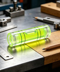 6Pcs Small Cylindrical Bubble Level Vials 10X35Mm Pmma Mini on a workbench with tools, featuring a bright green color.