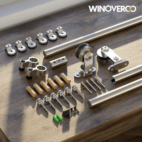 Top Mount Sliding Barn Door Hardware Kit Built Tough With Heavy Duty Stainless Steel Track and Slick Ball Bearing Rollers components laid out on wood.