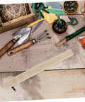 Ergonomic Wooden Handle Replacement For Gardening Tools Comfortable Grip For Weeding And Harvesting Fits Hand Sickles And Garden Trowels Durable Easy Install Tool Upgrade For Long Work Sessions on a wooden table with gardening tools.
