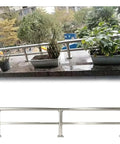 Premium 304 Stainless Steel Balcony Fence Post Extender Adding A Slick Top Rail Kit To Lock Down Deck Safety And Keep Pets Off The Railing Hassle Free For Outdoor Spaces on a balcony with potted plants.