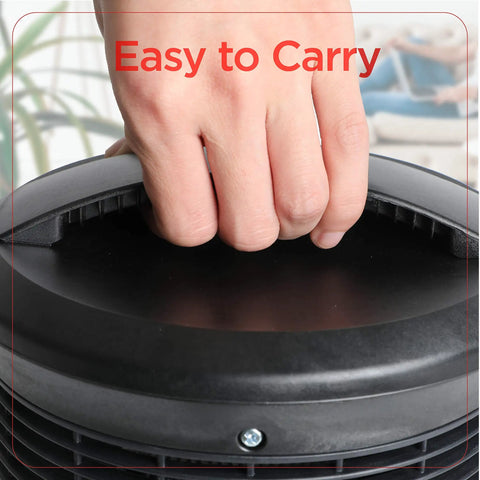 Close-up of a hand holding the handle of a 360 Degree Surround Desk Heater And Fan For Office And Home Use.