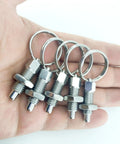 Four Pack Heavy Duty M12 Stainless Steel Spring Plunger With Pull Ring in hand, displaying shiny pins and secure rings.