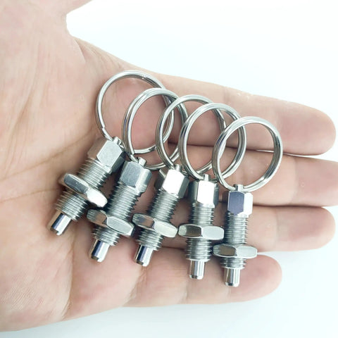Four Pack Heavy Duty M12 Stainless Steel Spring Plunger With Pull Ring in hand, displaying shiny pins and secure rings.