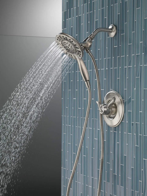 4-Setting In2ition 2-In-1 Dual Shower Head With Handheld Spray, Brushed Nickel Detachable Head With Hose, 1.75 GPM Flow, mounted on blue tiled wall.