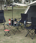 Four Pack Folding Camping Chairs Weigh Just Four Pounds, Ultra Portable With Carry Bag near a tent in a park setting.