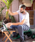 Person using Garden Cart With Rolling Seat And Adjustable Handle, 360 Degree Rotating Stool, on patio for planting