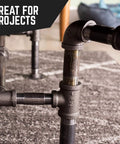 Close-up of 1/2 inch black pipe nipple in industrial furniture build, made from malleable cast iron with threaded fittings for DIY projects.
