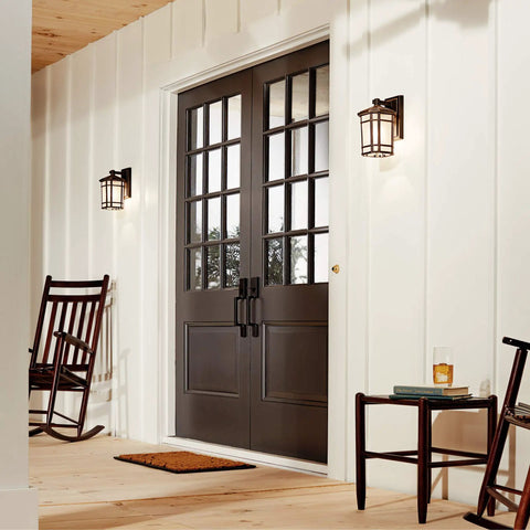 Cameron 1 Light Outdoor Wall Lantern In Prairie Rock Finish With Etched Linen Glass illuminating a porch by a dark door.