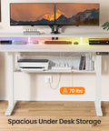 Ergonomic Electric Standing Desk 55 By 28 Inch Adjustable Sit Stand Workstation With Built In Bookshelf And Monitor Riser featuring dual monitors and LED lights.