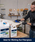 Person using 5 To 1 Marine Epoxy Resin Kit For Bonding, Coating, Filleting, And Laminating For Fiberglass, Wood, And Carbon Fiber Projects, Ideal For Boat Building, Repairs, And DIY Woodworking With Quart Slow Hardener And Pumps Included