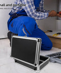Rock Solid Portable Aluminum Alloy Toolbox With Lockable Handle And Ample Hardware Storage Featuring Sleek Modern Design For No Sweat Home Repairs And Pro Grade Workshop Setup, open toolbox beside user crouching.