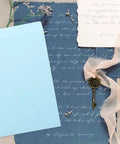 Thickened Self Adhesive Light Blue Envelope Mailing Bags 15 Pack For Postcards on a vintage background with a key and flowers.