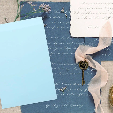 Thickened Self Adhesive Light Blue Envelope Mailing Bags 15 Pack For Postcards on a vintage background with a key and flowers.