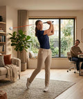 Woman using Golf Swing Trainer For At Home Practice With Instant Audio Feedback 47 Inch Indoor Training Aid in living room