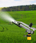 360 Degree Rain Gun Sprinkler With One And A Half Inch FNPT Connection spraying water in a lush green farm field