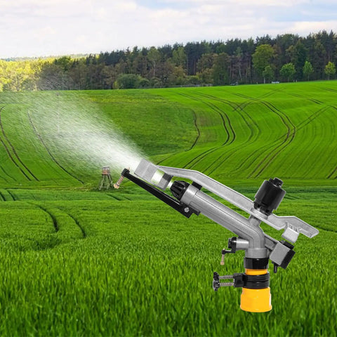 360 Degree Rain Gun Sprinkler With One And A Half Inch FNPT Connection spraying water in a lush green farm field
