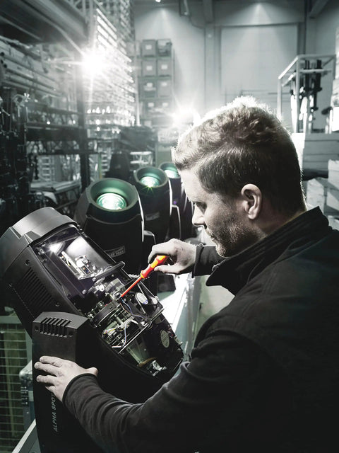 Technician using Kraftform Kompakt VDE 17 Universal 1 Tool Finder, 17 Piece Set with VDE Insulated Screwdrivers on machinery