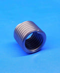Close-up of Inconel screw thread insert, part of Forty Five Piece Set Of One Half Inch By Thirteen Threads Per Inch And Three Quarter Inch Inconel Helical Screw Thread Inserts For Heavy Duty Repairs In Automotive And Industrial Equipment, shown on blue background.