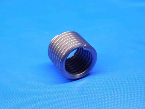 Close-up of Inconel screw thread insert, part of Forty Five Piece Set Of One Half Inch By Thirteen Threads Per Inch And Three Quarter Inch Inconel Helical Screw Thread Inserts For Heavy Duty Repairs In Automotive And Industrial Equipment, shown on blue background.