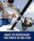 Battle IV 8 Ft Spinning Rod And Reel Combo Kit With 5000 Reel, CNC Gear Technology in use on boat with person holding fish