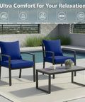 Two navy 24x24 Inch Outdoor Chair Cushions Set Of 2 With Removable Washable Covers, Water Repellent And Fade Resistant, Non Slip Bottom With Straps on black patio chairs by a pool.