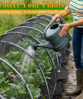 Person watering plants covered with Mosquito Netting 10x39 Feet 1Mm Mesh Garden Pest Barrier For Plants Fruit Trees And Vegetables