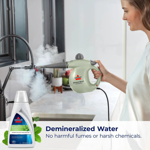 Person using steam mop with Eucalyptus Mint Demineralized Steam Mop Water, 32 Oz, White, Fresh Scent Cleaning Solution visible