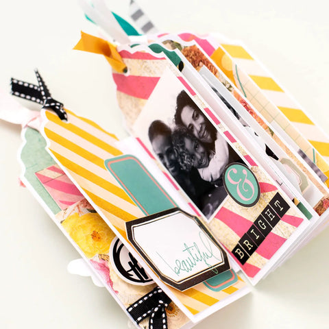 Scrapbook album with colorful tags made using 3-In-1 Round Tag Punch For Crafting And Scrapbooking, Multi Color Tool That Lets You Create Gift Tags, Planner Labels, Album Tags, And DIY Projects Fast With No-Fuss, Clean Rounded Edges.