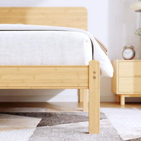 Natural Bamboo King Size Platform Bed Frame With Headboard features a close-up view of the sturdy wood legs and mattress.
