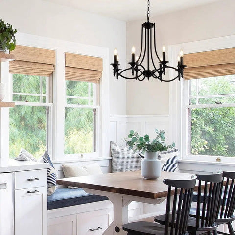 Industrial Candle Chandelier In Black Iron With Eight Lights hanging over a modern farmhouse dining area with a wooden table.