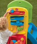 Toddler playing with Play Ball Fun Climber Backyard Playground Set For Toddlers 1.5+ With Slide, Ladder, Ball Drop Maze in yard.