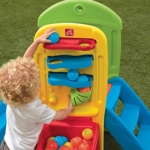Toddler playing with Play Ball Fun Climber Backyard Playground Set For Toddlers 1.5+ With Slide, Ladder, Ball Drop Maze in yard.