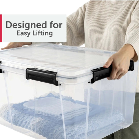 Close-up of a person lifting a Massive 80 Quart Clear Plastic Storage Bin With Hella Tight Waterproof Seal and Heavy Duty Latches.