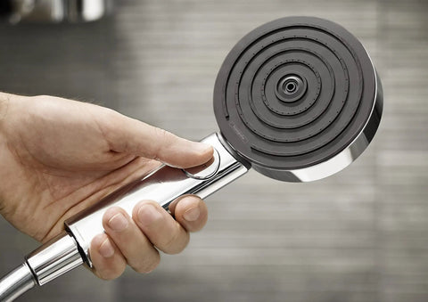 Close-up of hand holding Pulsify S Handheld Shower Head Set With 3 Spray Modes QuickClean And Hose in Chrome 2.5 GPM Flow