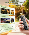 Person holding remote for 96 Ft Outdoor Solar String Lights With Remote And USB Port, dimming modes displayed