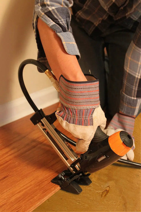 Person using Pro Grade Pneumatic 20 Gauge L Cleat Flooring Nailer For Tongue And Groove DIY Friendly Hardwood Installs.