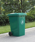 Rock Solid 240L Outdoor Trash Can With Flip Top Lid And Smooth Rolling Wheels Galvanized Steel Roll Bin Truck Ready For Commercial Garbage Hauling Green placed on a sidewalk.