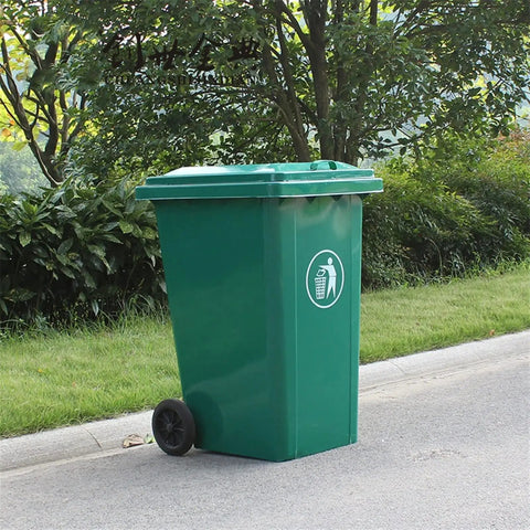 Rock Solid 240L Outdoor Trash Can With Flip Top Lid And Smooth Rolling Wheels Galvanized Steel Roll Bin Truck Ready For Commercial Garbage Hauling Green placed on a sidewalk.