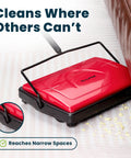 No Sweat Push Powered Carpet Sweeper With Triple Brush Heads For Big Time Dust Pickup On Area Rugs And Vinyl Floors grabs debris near couch.