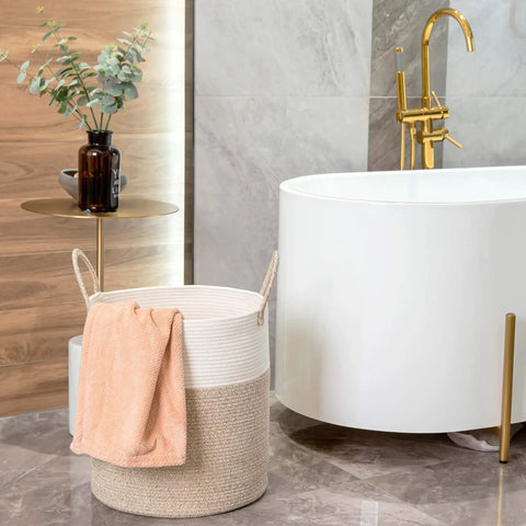 Huge Cotton Rope Storage Basket 18 By 16 Inches Decorative Woven Laundry Hamper next to a bathtub with a towel, in a bathroom setting.