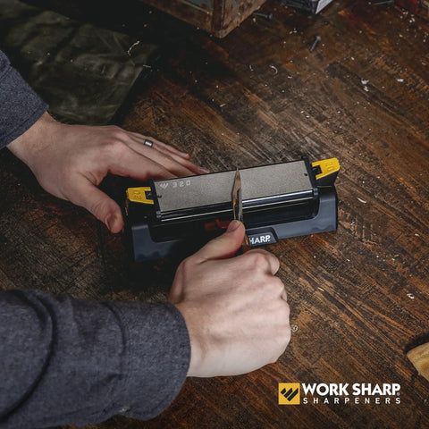 Using Three Sided Benchstone Knife Sharpener with diamond and ceramic abrasives on wooden table for fast, precise sharpening.